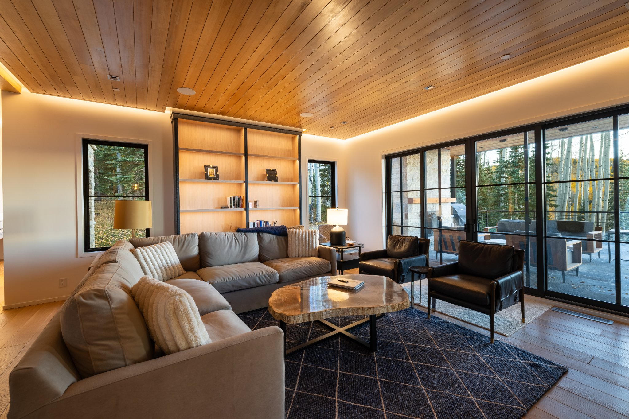 Great room — sectional seating, built-in bookshelves, mountain light